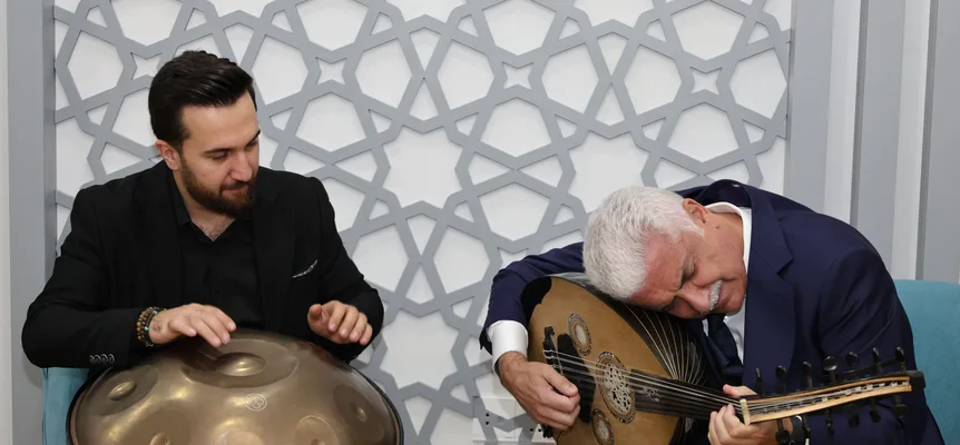 Two musicians playing an oud and a handpan indoors