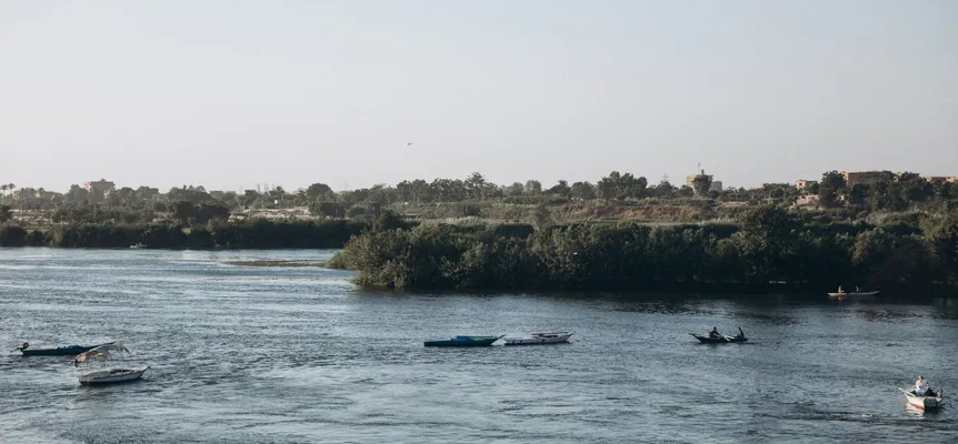 Small wooden boats moored on the Nile under a clear sky