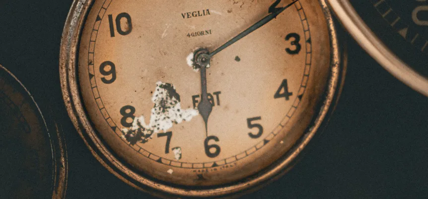 Close-up of a worn vintage analogue clock face